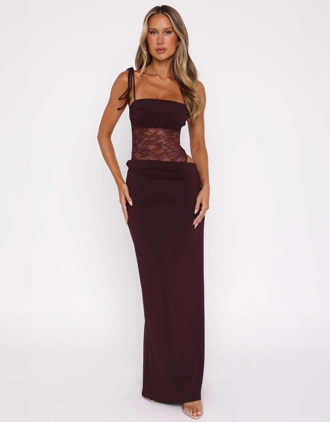 Pale yellow Abigail lace maxi dress with delicate spaghetti straps and a sheer lace bodice, styled in a modern living space.