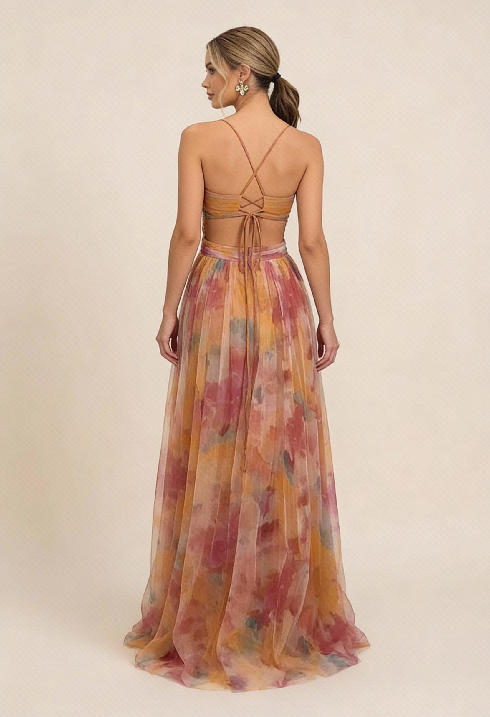 Back view of the Addison Watercolor Maxi Dress, highlighting the delicate criss-cross strap detail and full-length skirt.