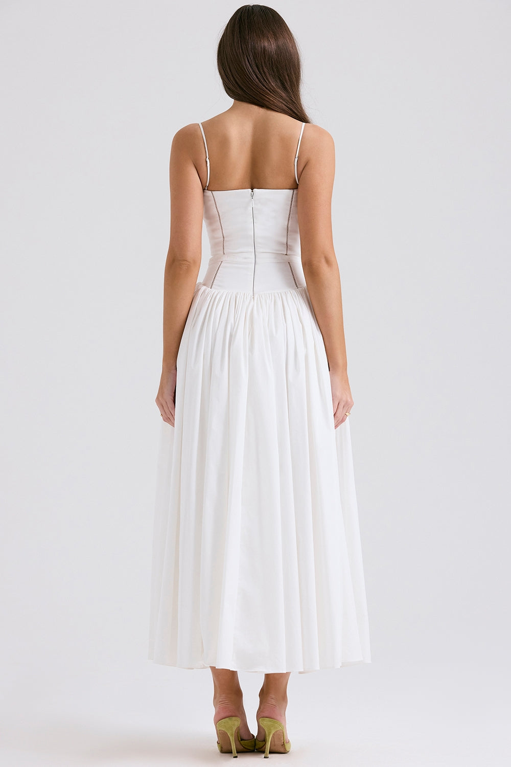 Back of the solid white Adeline Corset Midi Dress, highlighting the clean lines of the bodice and the flowing midi skirt.