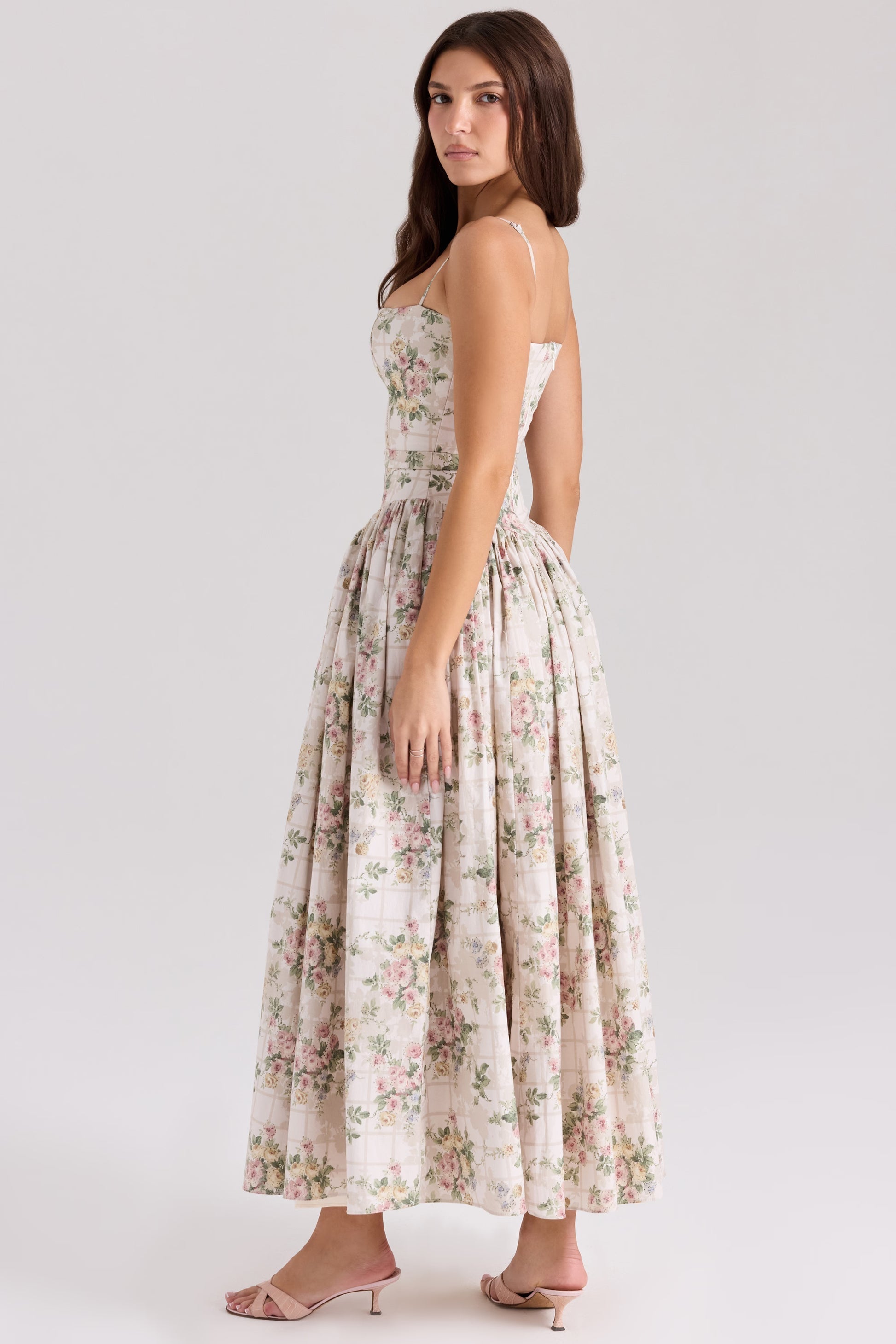 Rear side view of the off-white Adeline Corset Midi Dress, showing the elegant silhouette and intricate floral design.