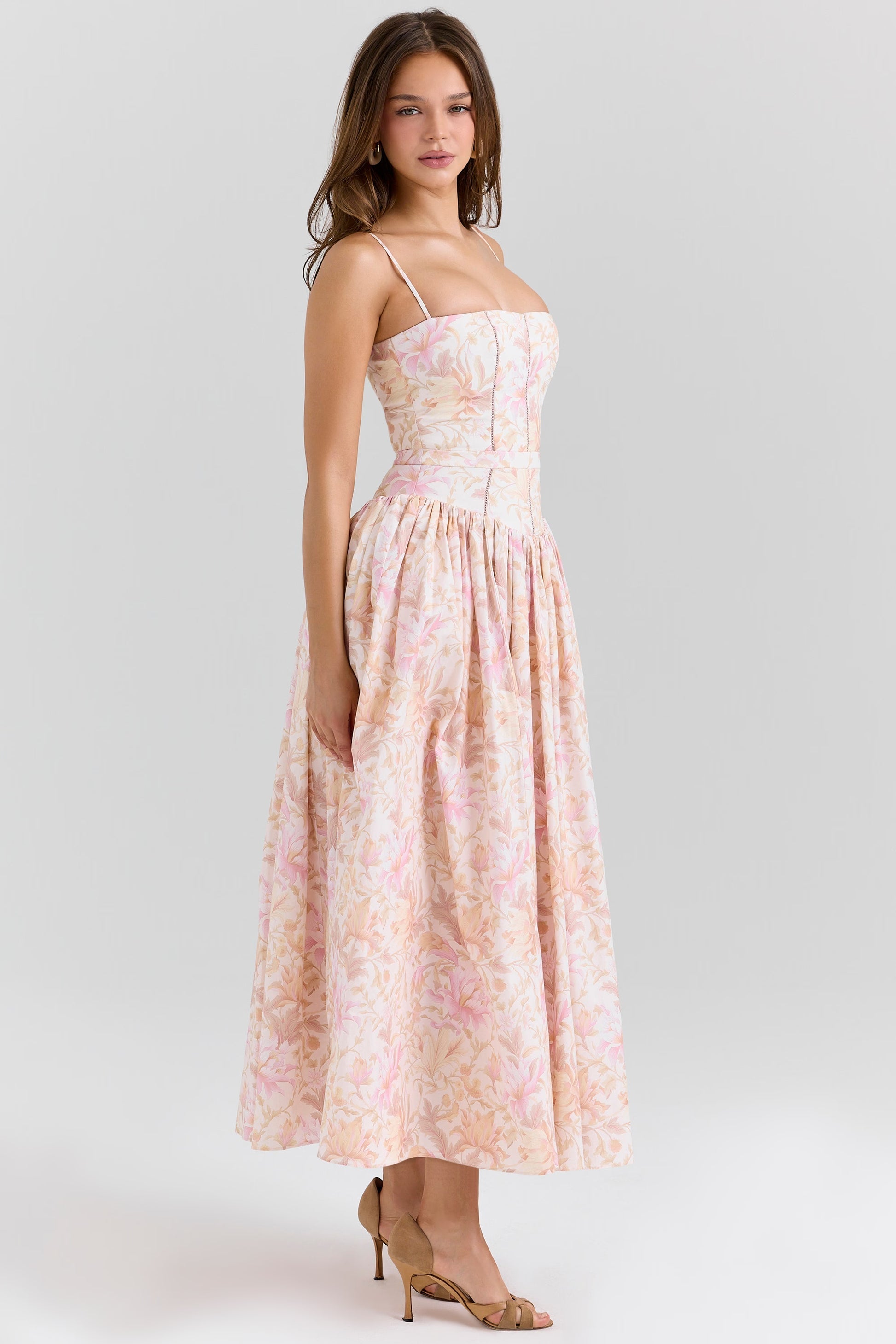 Side profile of the pink and orange floral Adeline Corset Midi Dress, emphasizing the structured bodice and midi length.