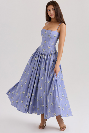 Full shot of the Adeline Corset Midi Dress in a periwinkle blue with white floral and vine pattern, in a dynamic pose.