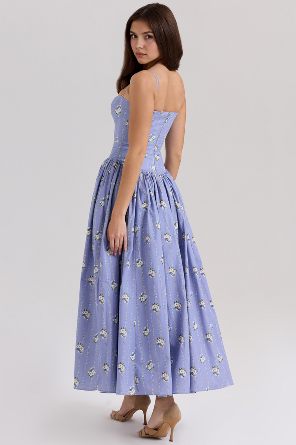 Back view of the periwinkle blue Adeline Corset Midi Dress, featuring white floral vines and a flowing midi skirt.