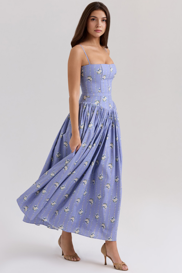 Front view of an Adeline Corset Midi Dress in periwinkle blue with a delicate white floral print, featuring thin straps and a flowing skirt.