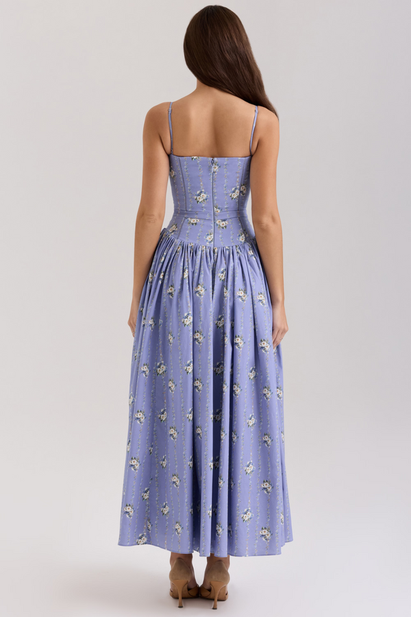 Back view of the Adeline Corset Midi Dress, showcasing the periwinkle blue fabric with white floral pattern and a hidden zipper closure.
