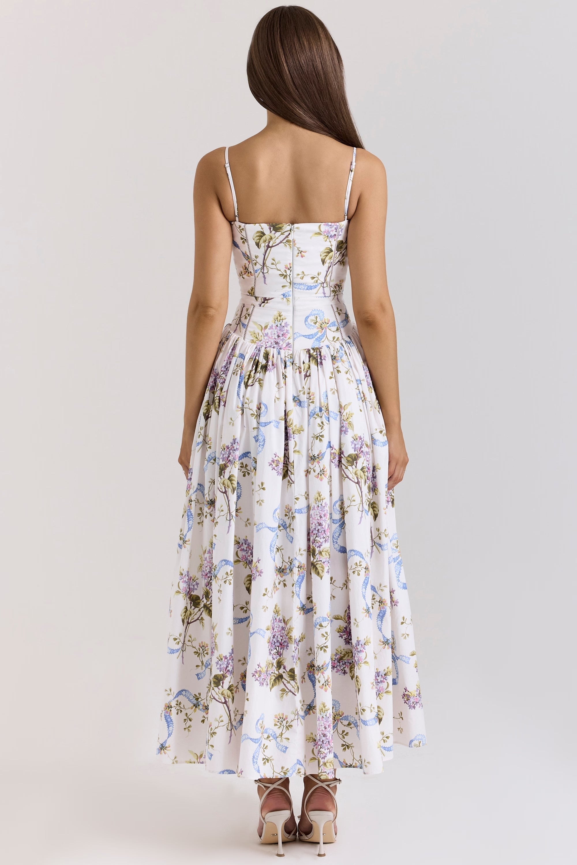 Back view of the Adeline Corset Midi Dress, highlighting the floral pattern, corset back, and full midi length skirt.