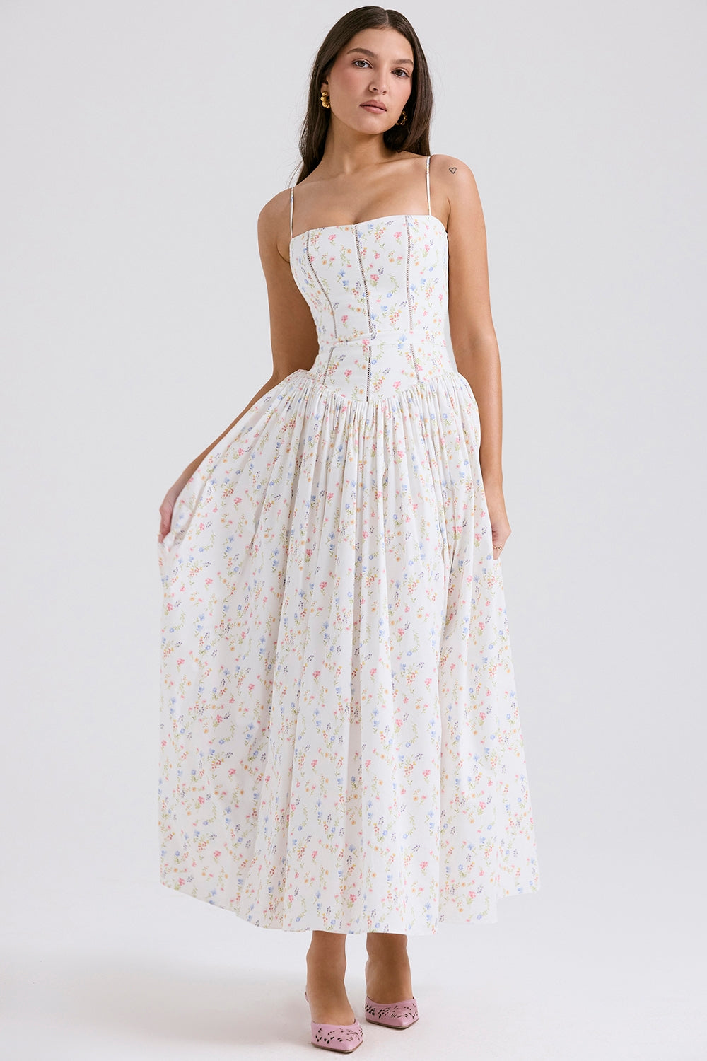 White Adeline Corset Midi Dress with a subtle multi-color floral print, spaghetti straps, and a flowy gathered skirt.