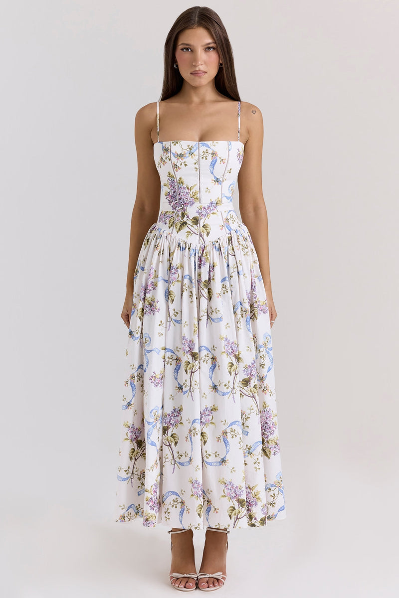 White Adeline Corset Midi Dress with delicate purple floral and blue ribbon pattern, spaghetti straps, and a gathered skirt.