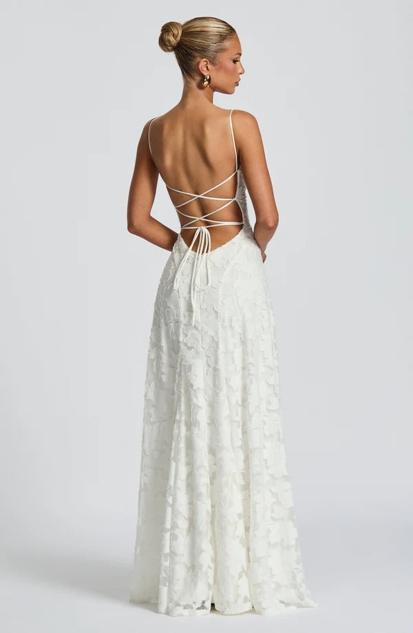 Back view of the elegant white floral maxi dress, featuring a delicate lace-up back and long skirt.