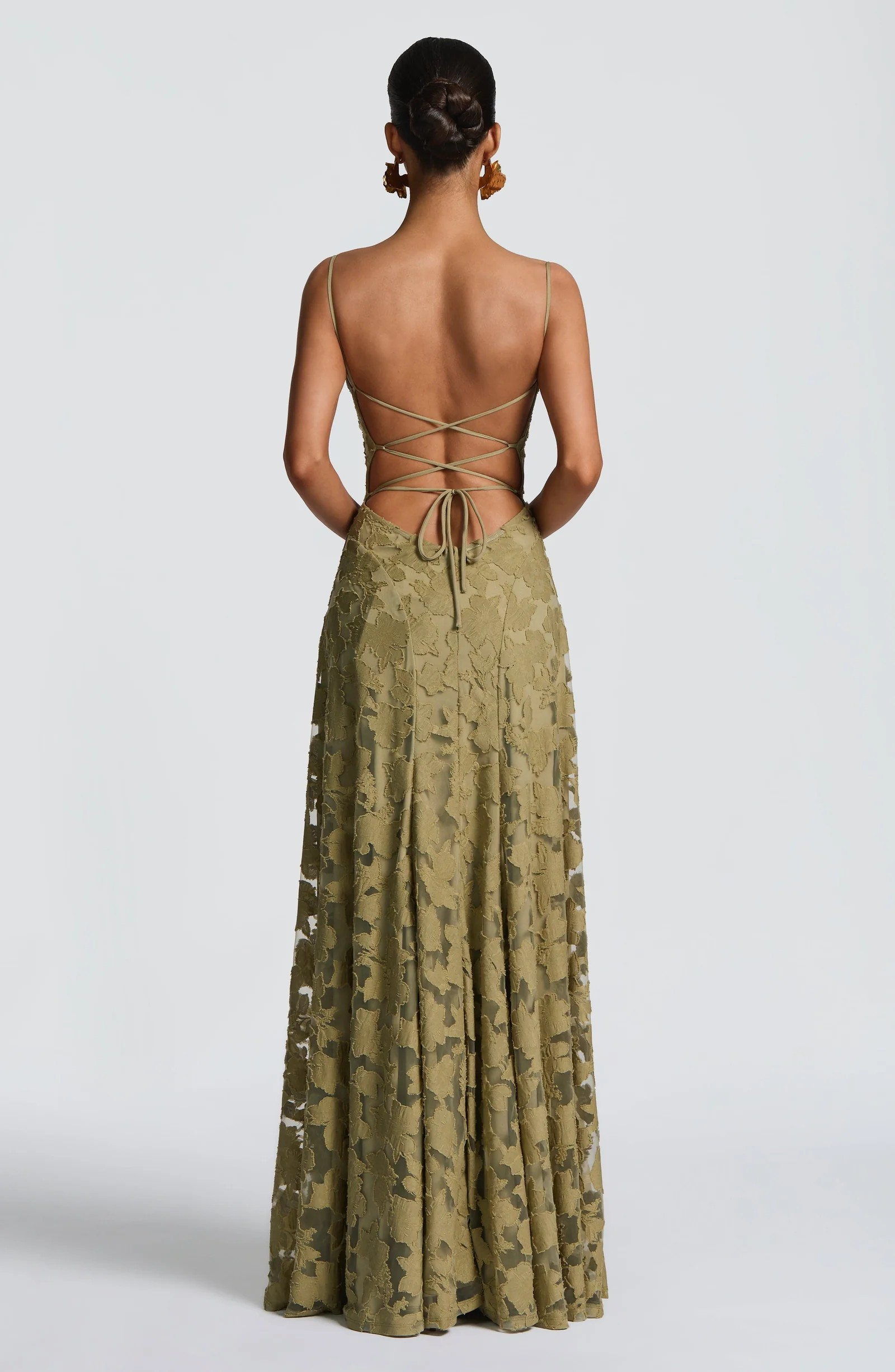 Back view of the Adrianna Floral Maxi Dress, showcasing the intricate lace-up detail and the flowing skirt with a floral design.