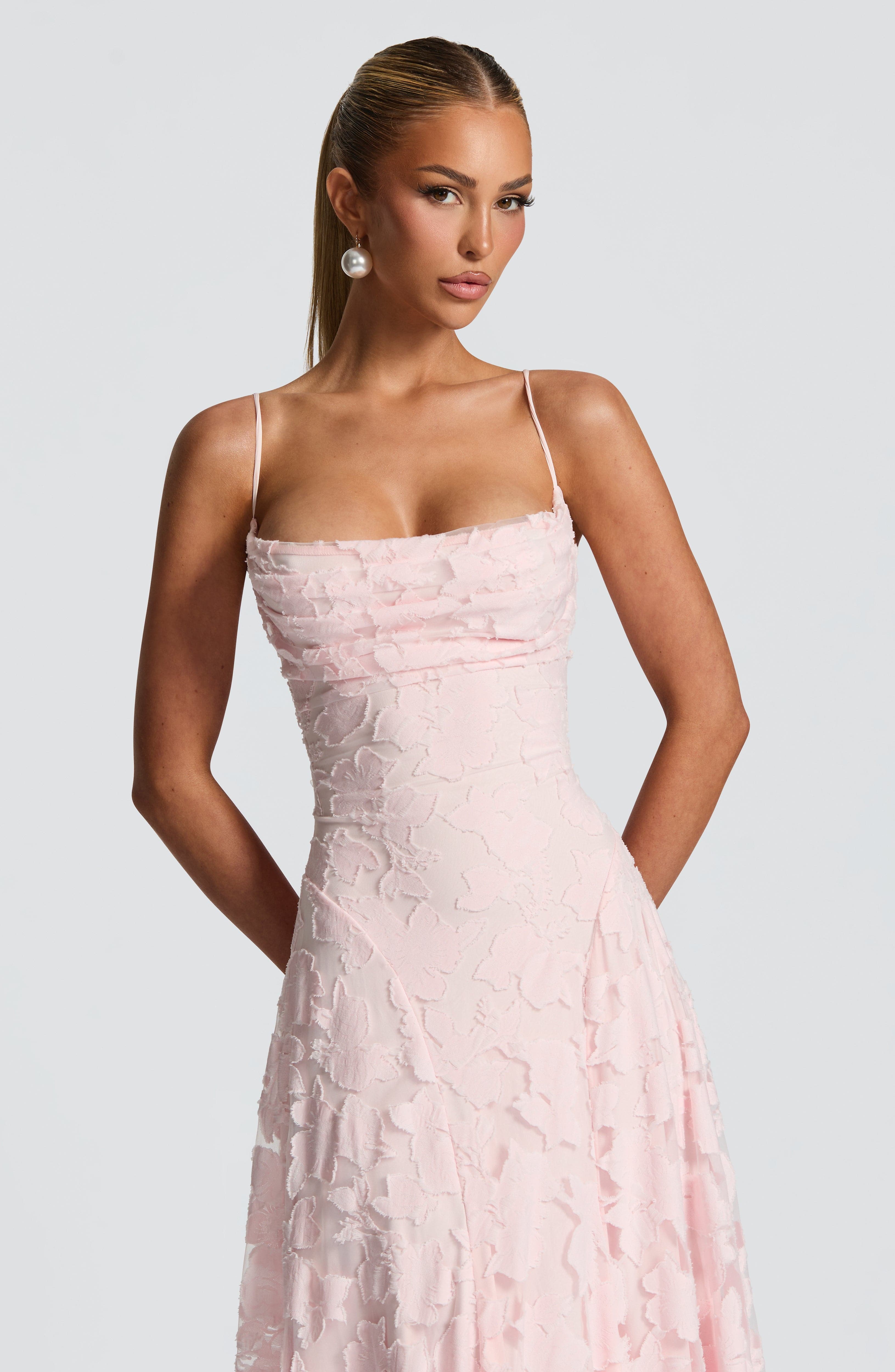 Close-up of the bodice and waist of the pink floral maxi dress, showing textured fabric details.