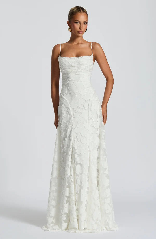 Full-length white floral maxi dress with a square neckline, thin straps, and a structured bodice.