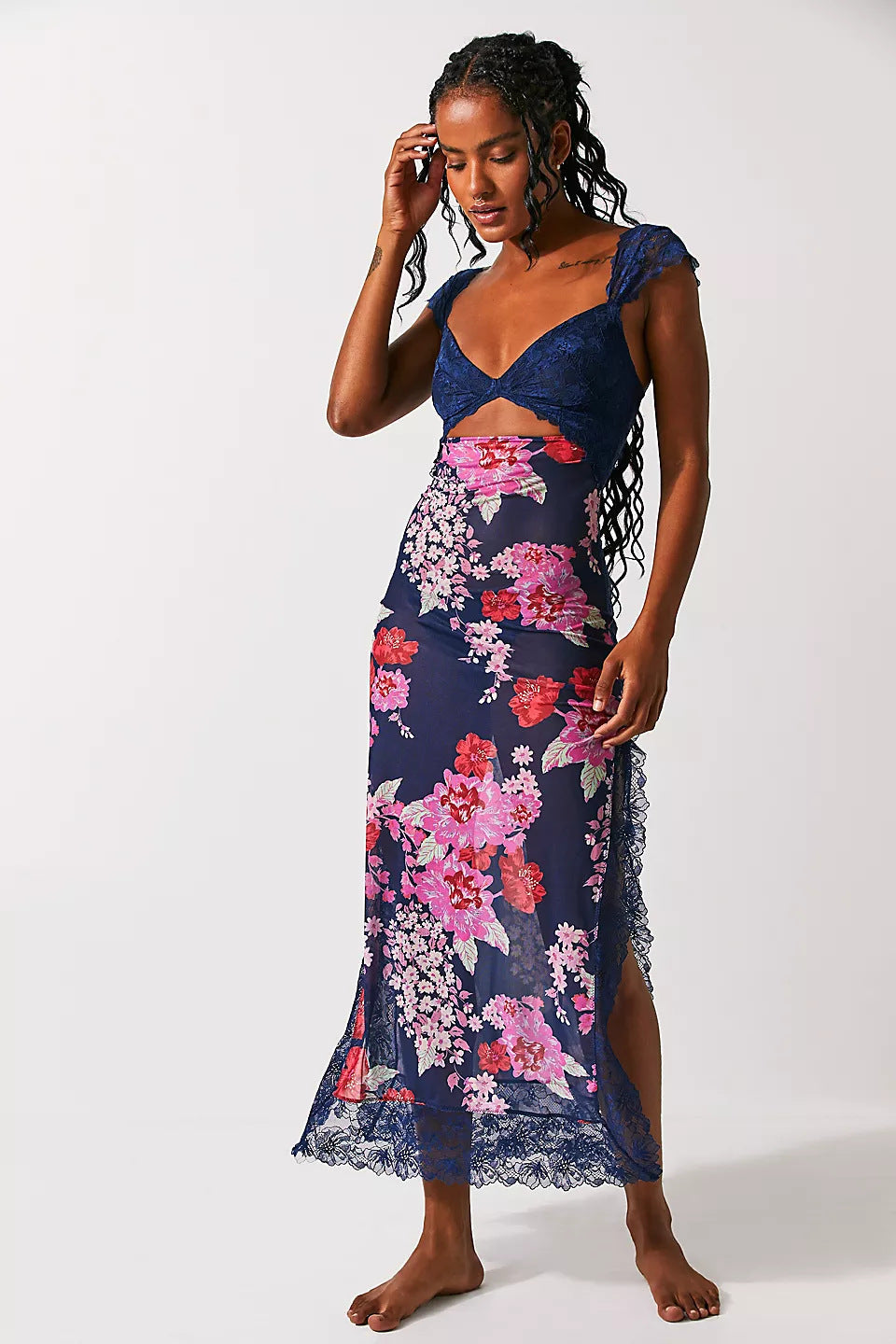 Front view of Aisha backless maxi dress in navy blue with pink and red floral print, lace bust, and side slit.