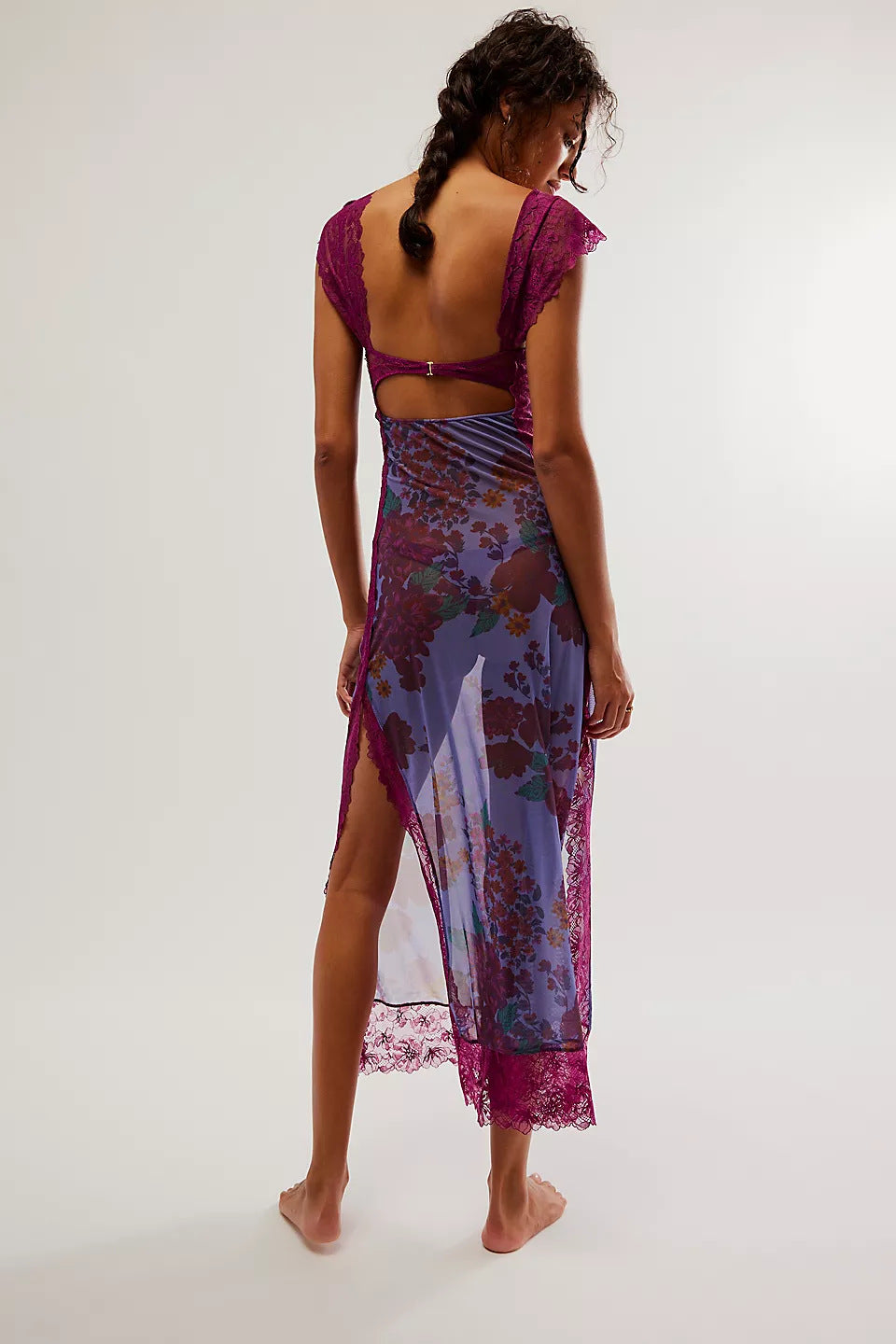 Back view of Aisha backless maxi dress in purple with dark floral print, showing lace trim and open back design.