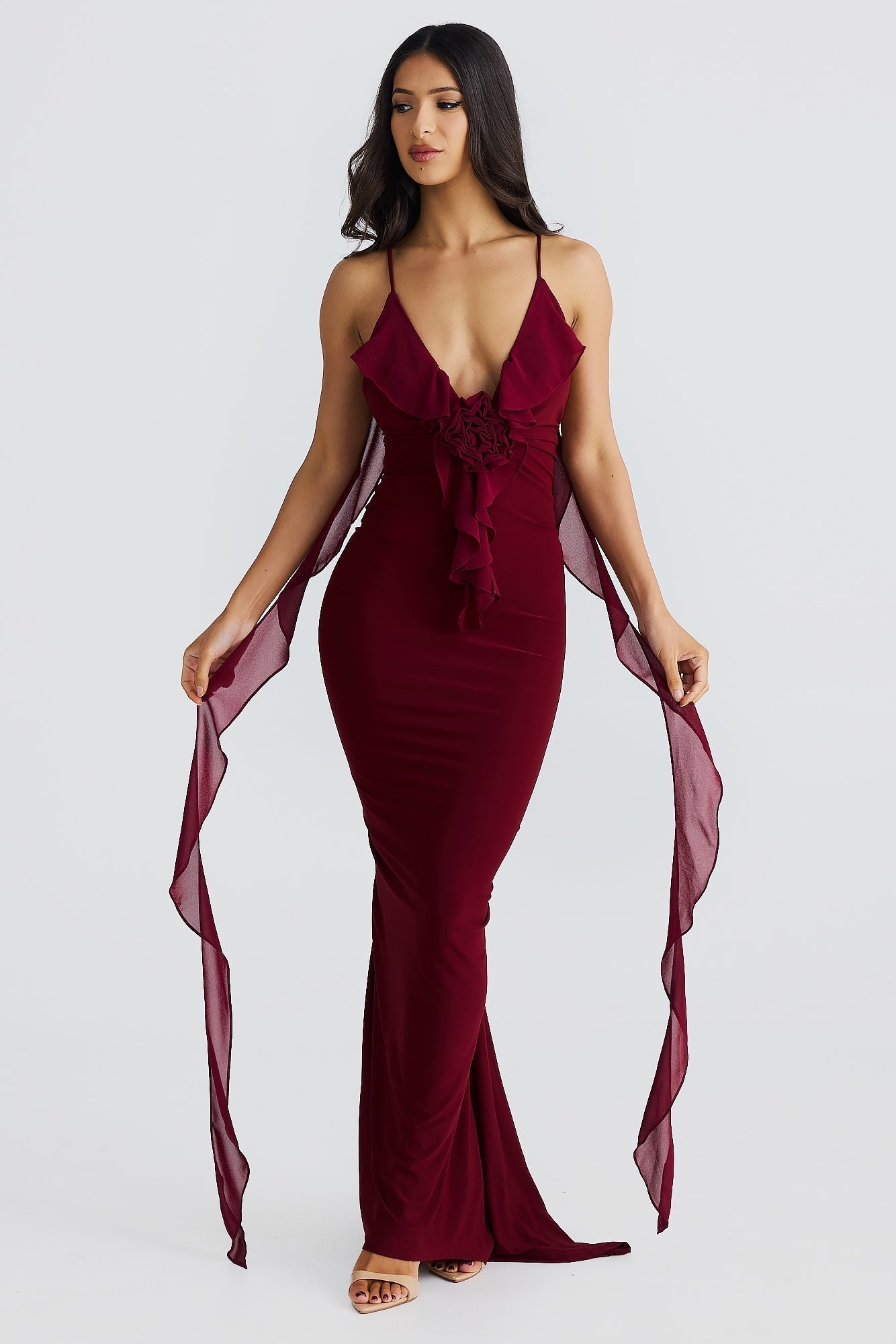 Front view of a rich burgundy Alexa Ruffle Maxi Dress, highlighting the ruffled bodice with a central rose detail and long chiffon accents.