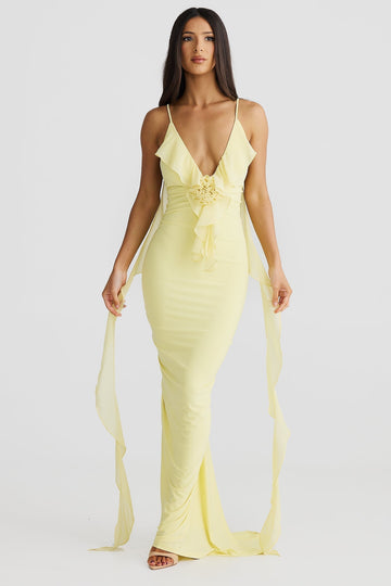 Front view of a light yellow Alexa Ruffle Maxi Dress with a deep V-neck and delicate shoulder straps, featuring a ruffled bodice and long flowing chiffon sashes.