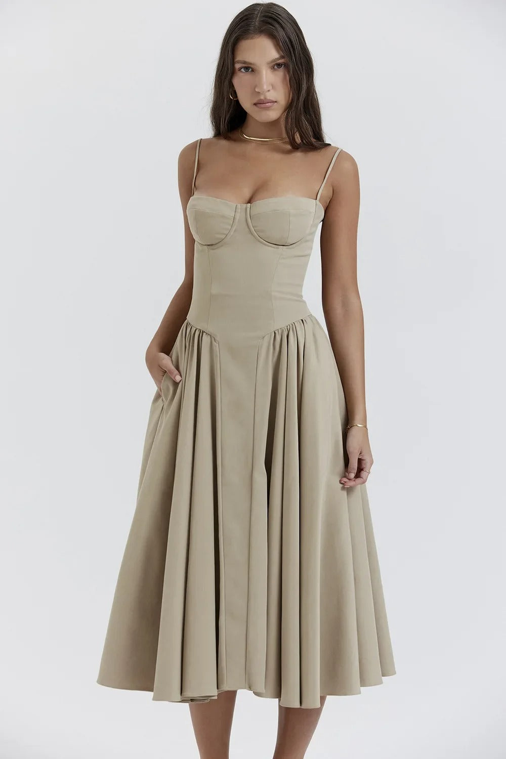Front view of a light beige Alexandra corset midi dress with a full pleated skirt and delicate straps.