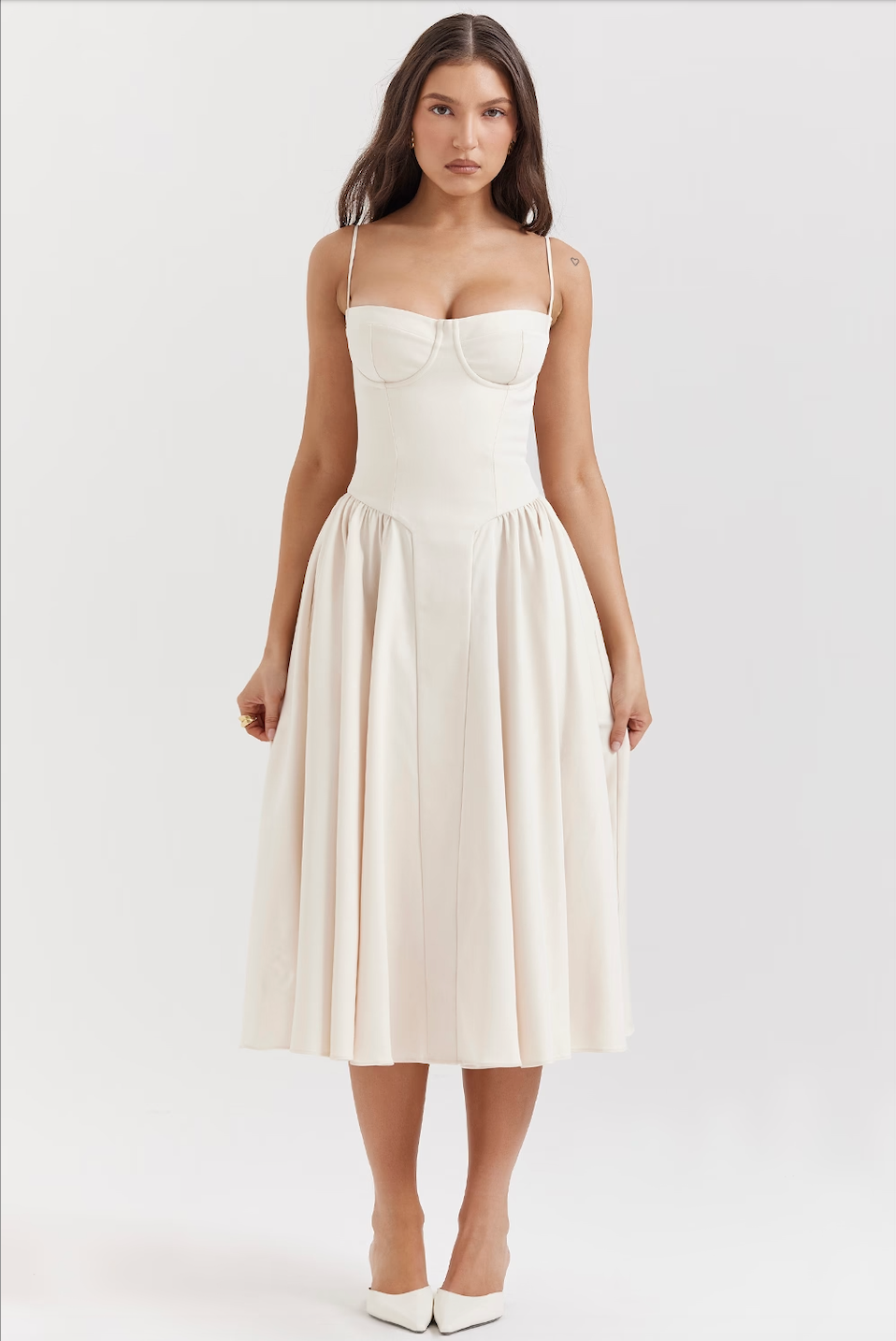 Front view of an off-white corset midi dress with a structured bodice and a gracefully pleated skirt, perfect for wedding suits for women.