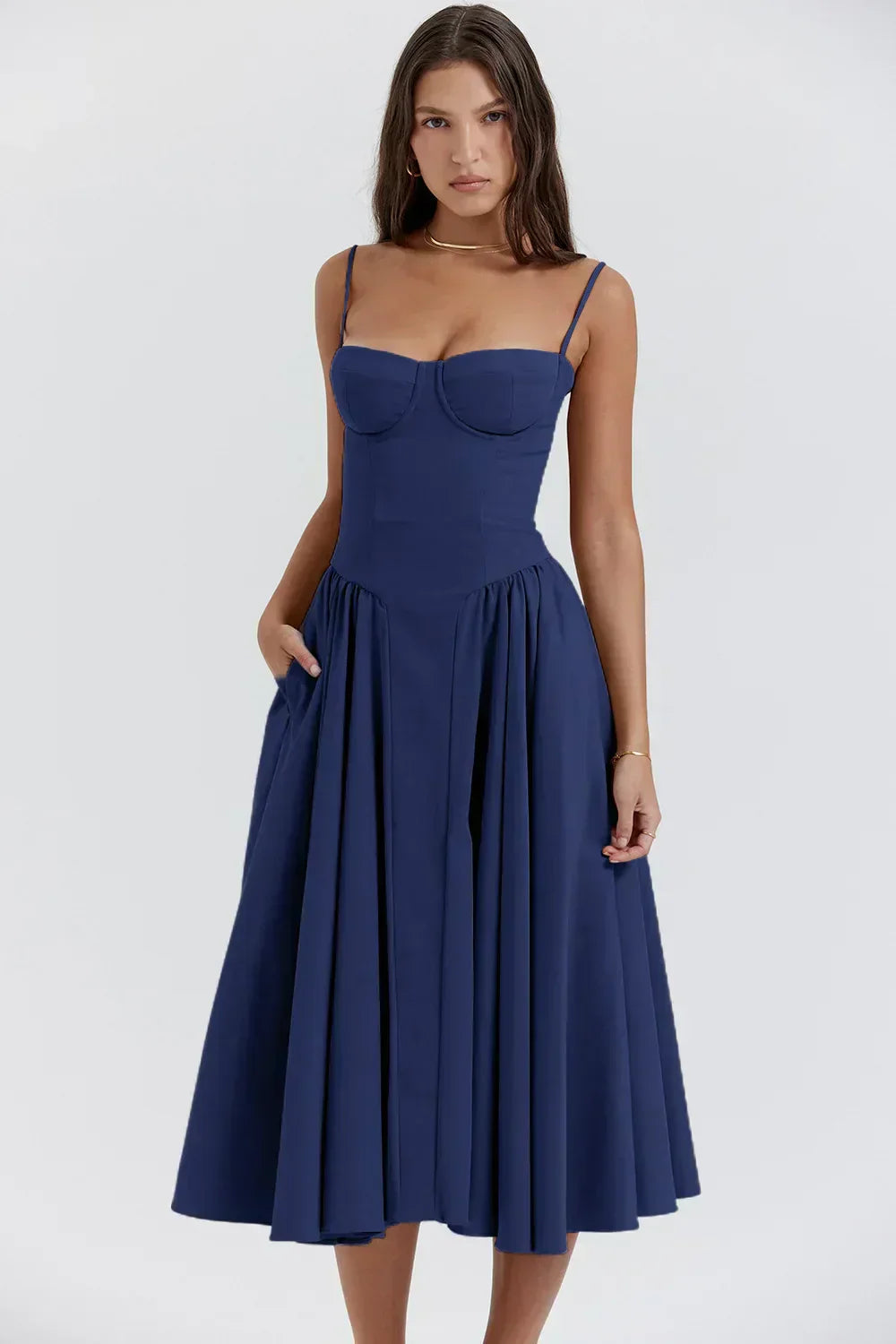 Navy blue Alexandra corset midi dress featuring a sweetheart neckline, full pleated skirt with pockets, and thin straps.