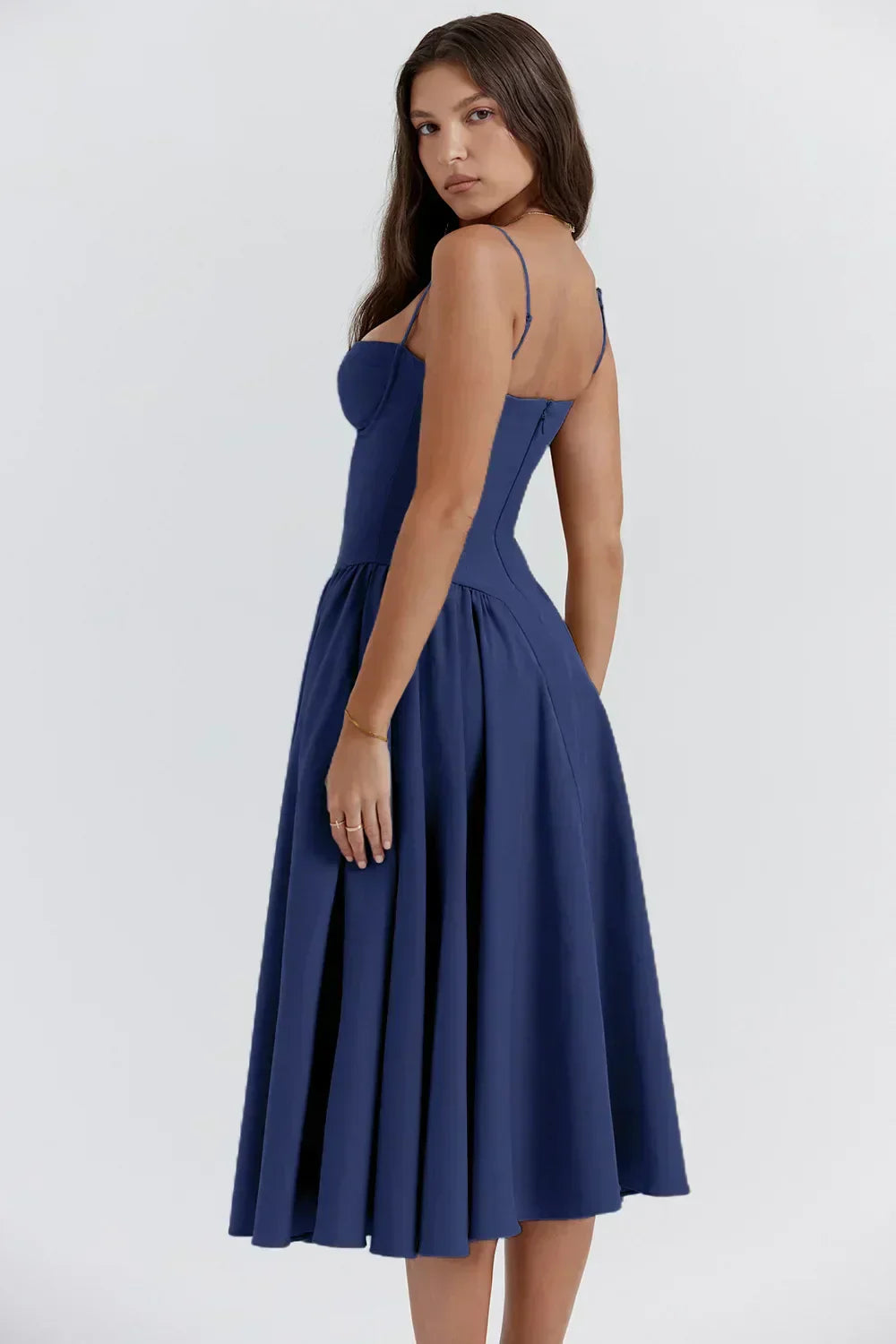 Back view of the navy blue Alexandra corset midi dress, highlighting the fitted bodice and flowing pleated skirt.