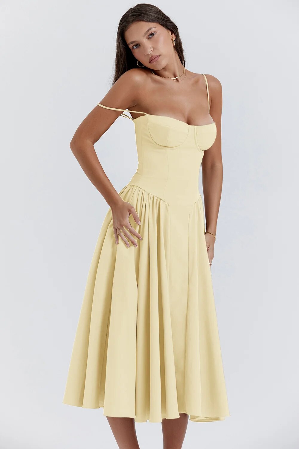 Pale yellow Alexandra corset midi dress with one strap pulled down, showcasing the sweetheart neckline and full skirt.