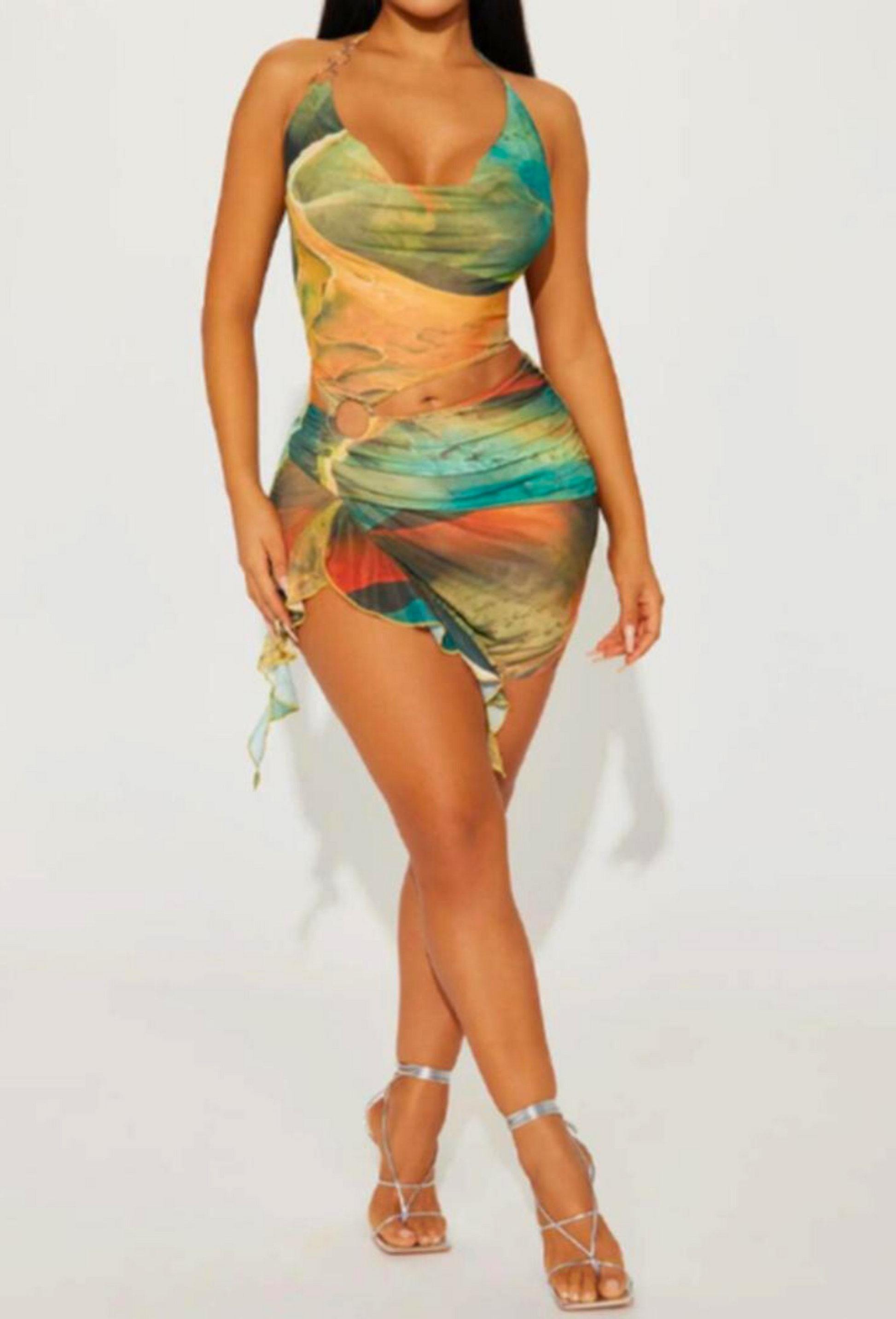 Full body shot of the Alexandra Cutout Mini Dress in a multi-color abstract print, featuring a halter top and mini skirt with ruffles.