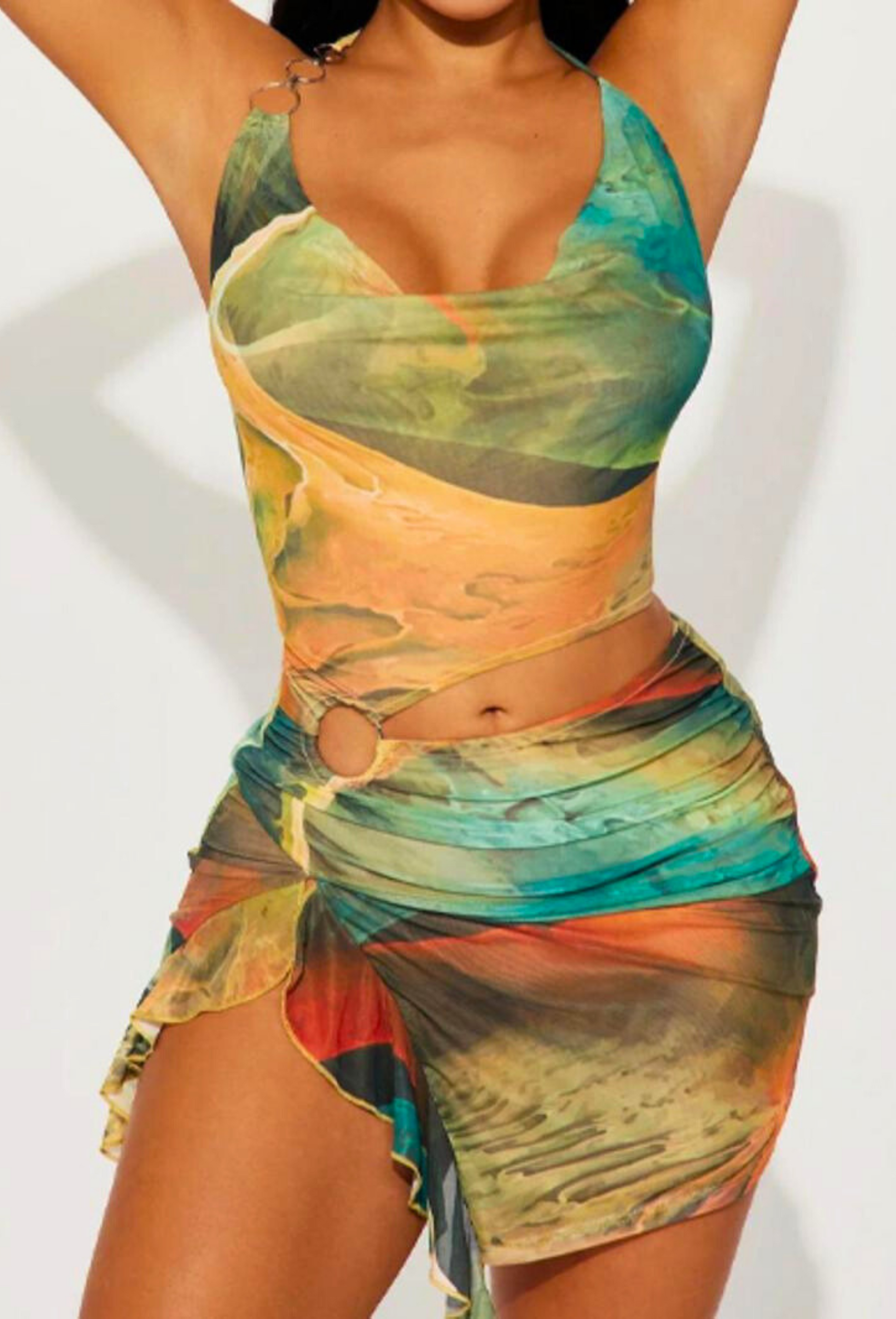 Front view of the Alexandra Cutout Mini Dress in a colorful green, orange, and blue abstract print, with a halter neck and side ring detail.