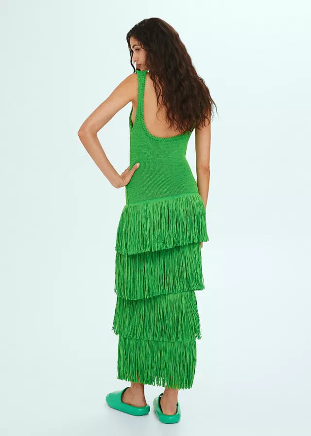 Back view of the green tiered fringe midi dress, highlighting the layered fringe and a low back design.