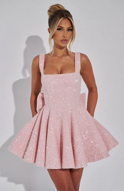 Front view of a white sequin mini dress with a square neckline and a large bow detail at the back, perfect for wedding suits for women.