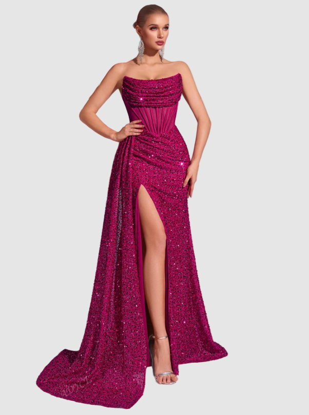 Fuchsia pink sequin maxi dress with a strapless gathered neckline, structured corset, and a dramatic high leg slit.