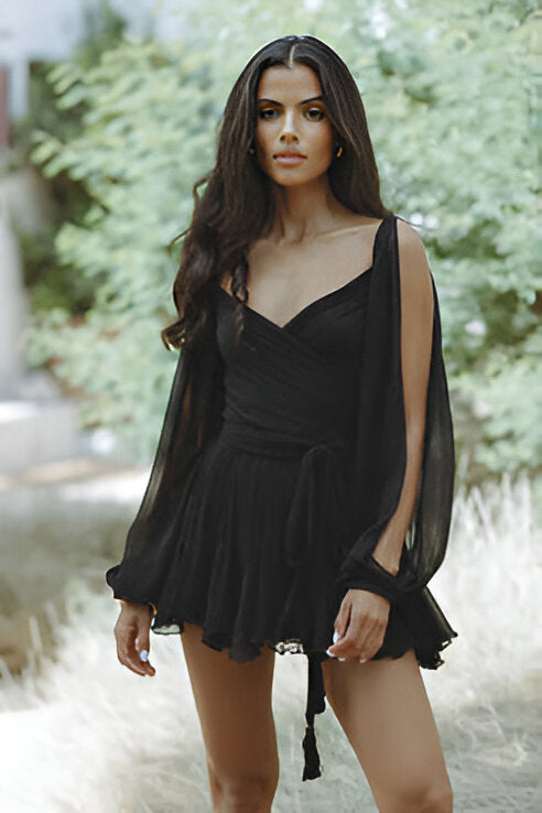 Front view of a chic black Amira Draped Mini Dress, featuring a deep V-neck and sheer long sleeves.