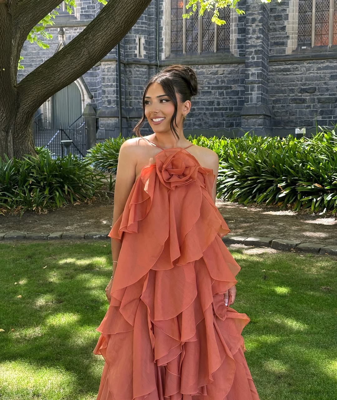 Close-up of the bodice of the peach Andrea Ruffle Maxi Dress, highlighting the ruffled layers and floral bust detail.