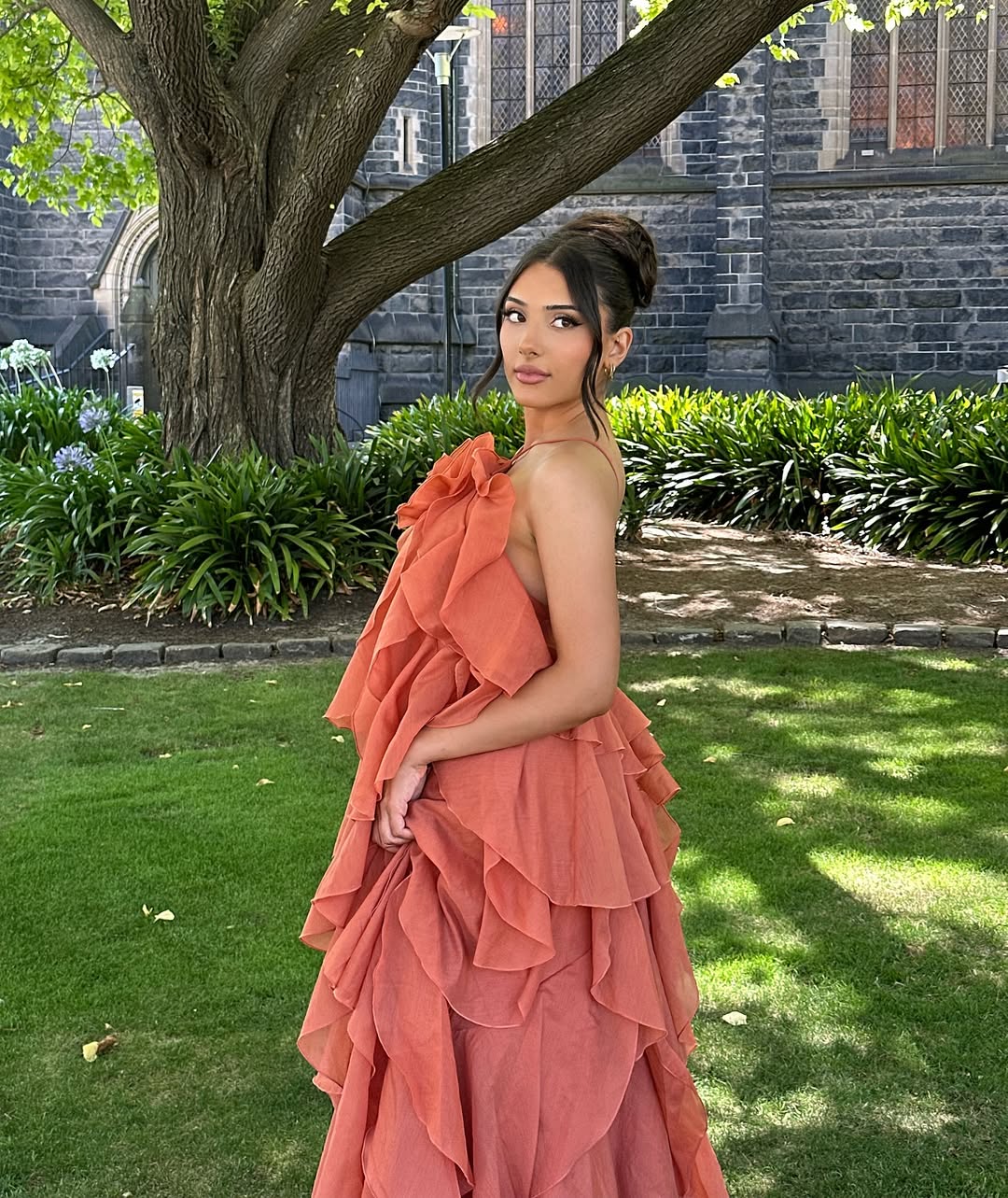 Three-quarter view of the peach Andrea Ruffle Maxi Dress, emphasizing the full skirt and ruffled texture.