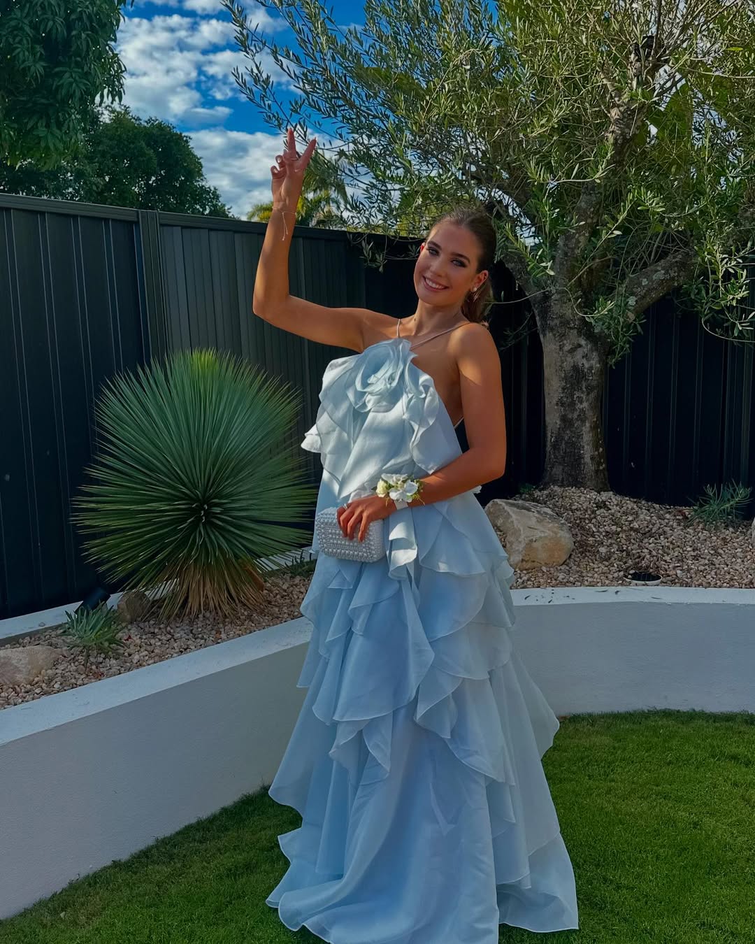 Full length view of the light blue Andrea Ruffle Maxi Dress, showing the flowing ruffles and strapless neckline.