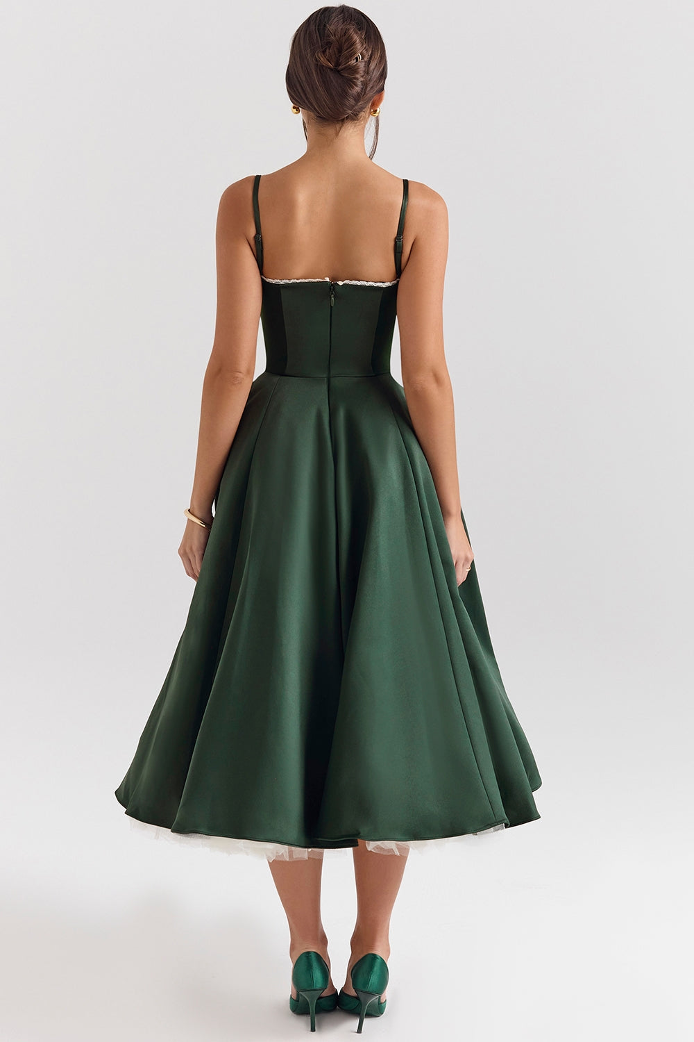 Back view of a dark green Angela Corset Midi Dress, showing the full skirt, spaghetti straps, and white lace trim detail.