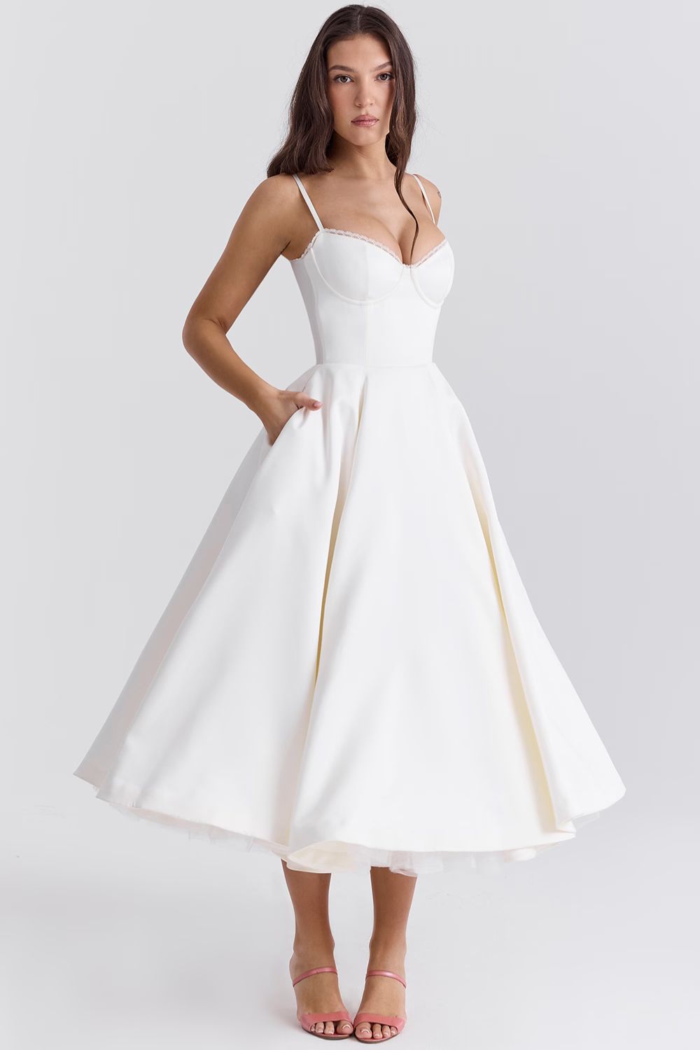 Front view of a white Angela Corset Midi Dress with a full skirt and pockets, showing white lace trim on the bust.