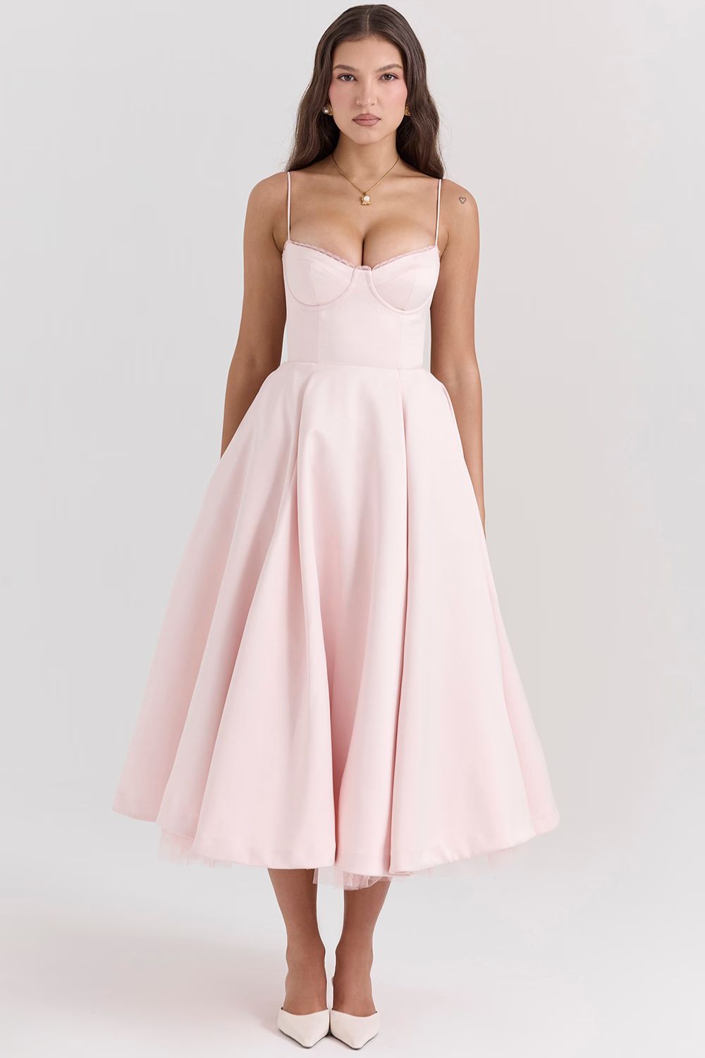 Front view of a pastel pink Angela Corset Midi Dress with a wide, flowing skirt and delicate white lace trim along the bustline.