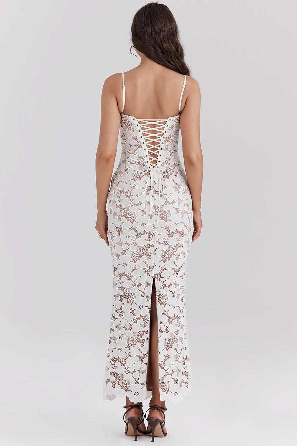 Back view of a white lace bodycon maxi dress for women, highlighting the lace-up corset detail and back slit.