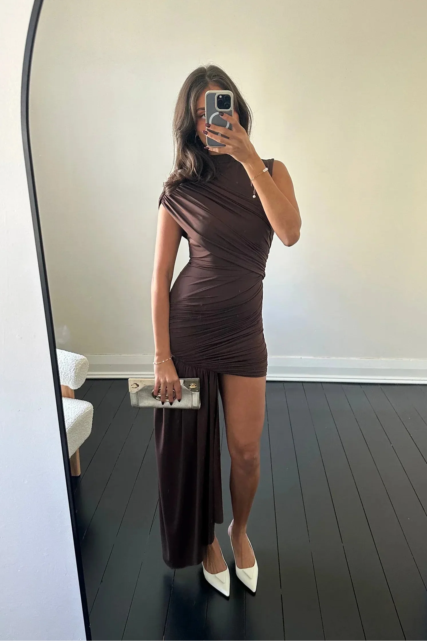 Mirror shot of brown Aria Ruched Mini Dress, showing the sleeveless cut and the unique long draped fabric on one side.