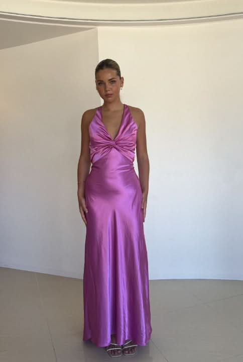 Full front view of a purple satin maxi dress, featuring a flattering twisted halter neckline and a flowing skirt.