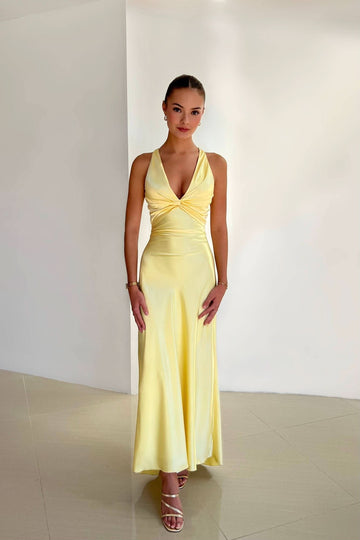 Full-length yellow satin maxi dress with a twisted halter neckline and open back design, perfect for special occasions.