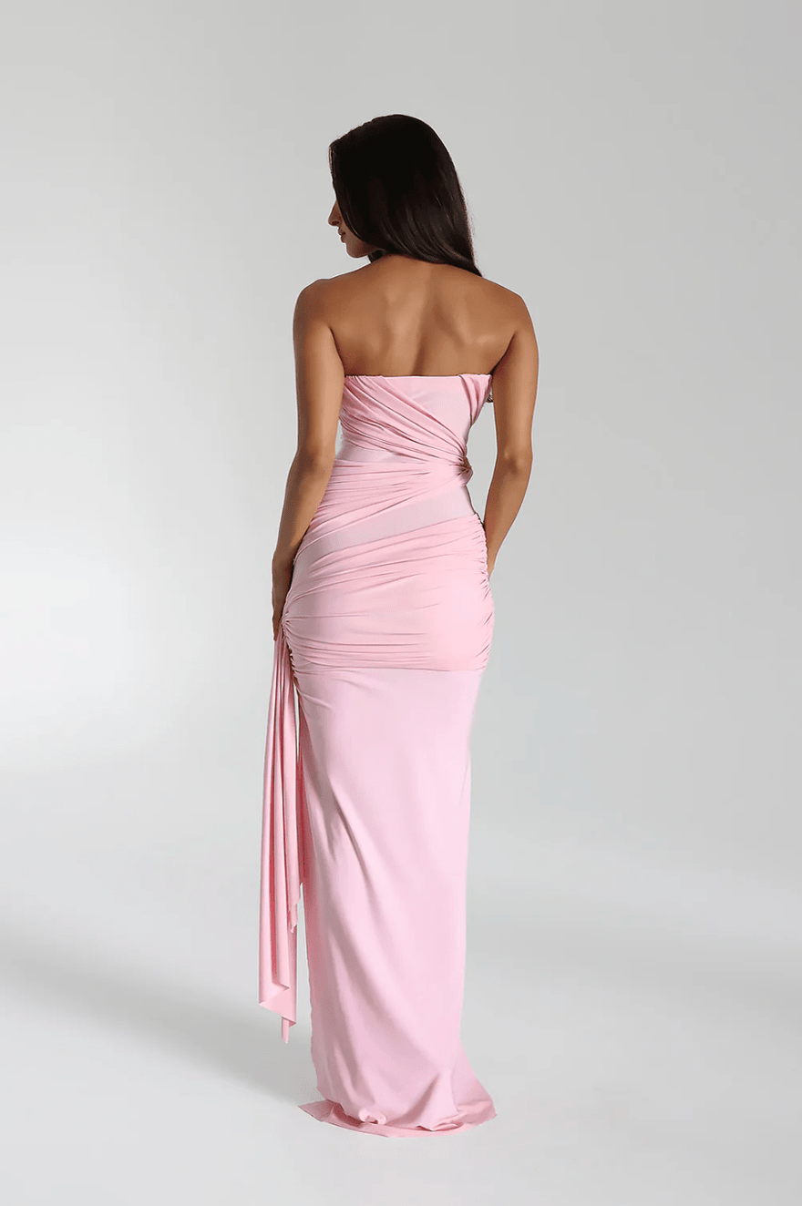 Back view of blush ruched strapless maxi dress, highlighting bodycon fit and draped detailing for women