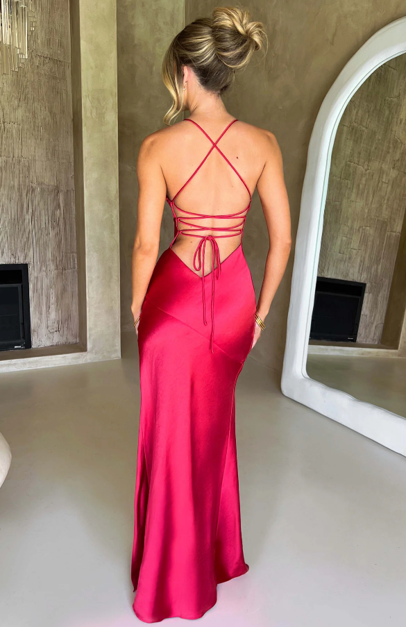 Back view of a vibrant magenta Athena Plunge Maxi Dress, showcasing the intricate criss-cross lace-up design.