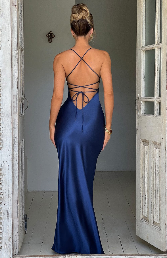 Rear view of a navy blue Athena Plunge Maxi Dress, displaying the criss-cross strap detailing across the back.