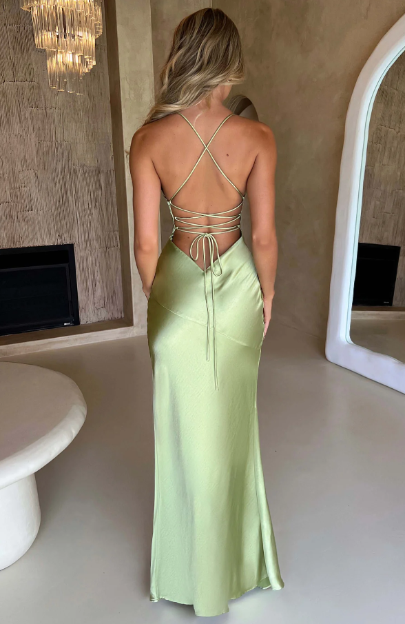 Full back view of a light sage green Athena Plunge Maxi Dress, showcasing the elegant lace-up design and long skirt.