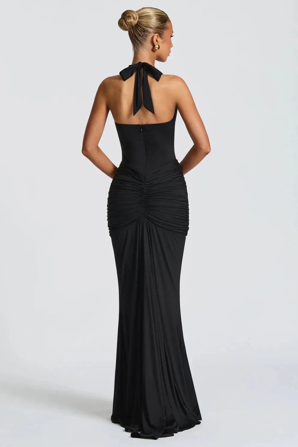 Full-length black maxi dress showcasing elegant ruching and flowing train.