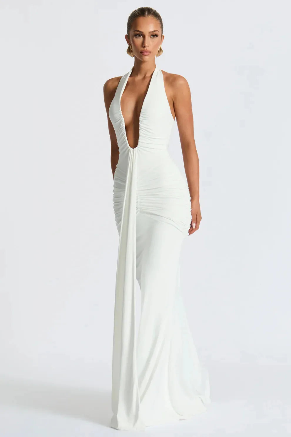 Back view of black maxi dress with halter neck tie and fluid silhouette.