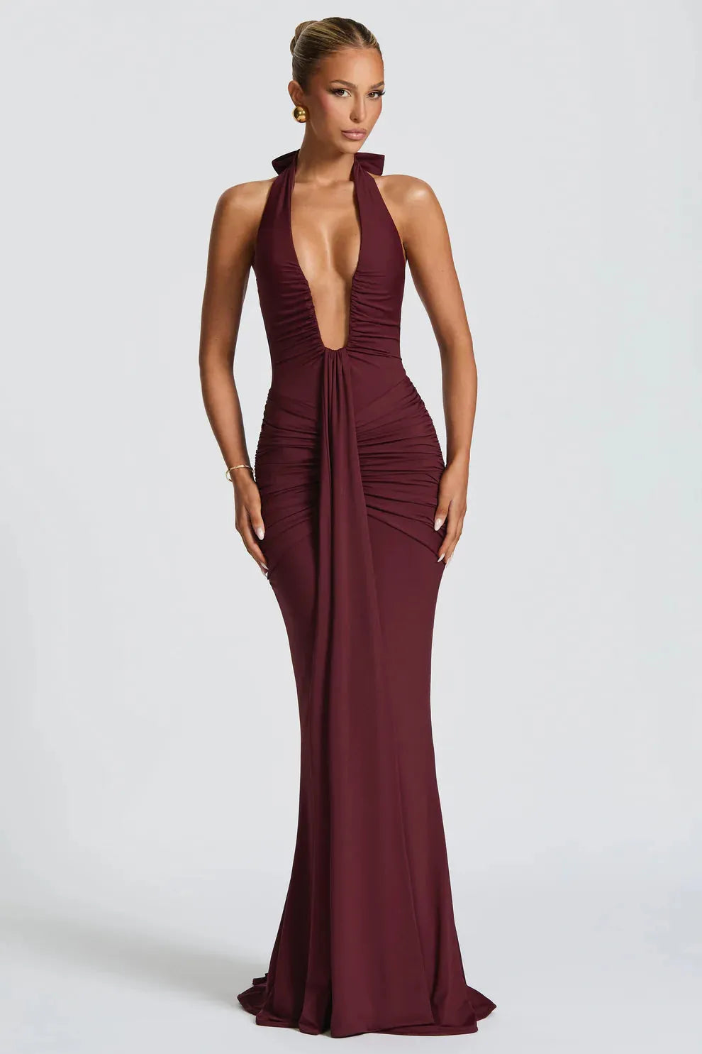 Full-length burgundy ruched maxi dress with a deep V-neck halter, front view, showing draped details.