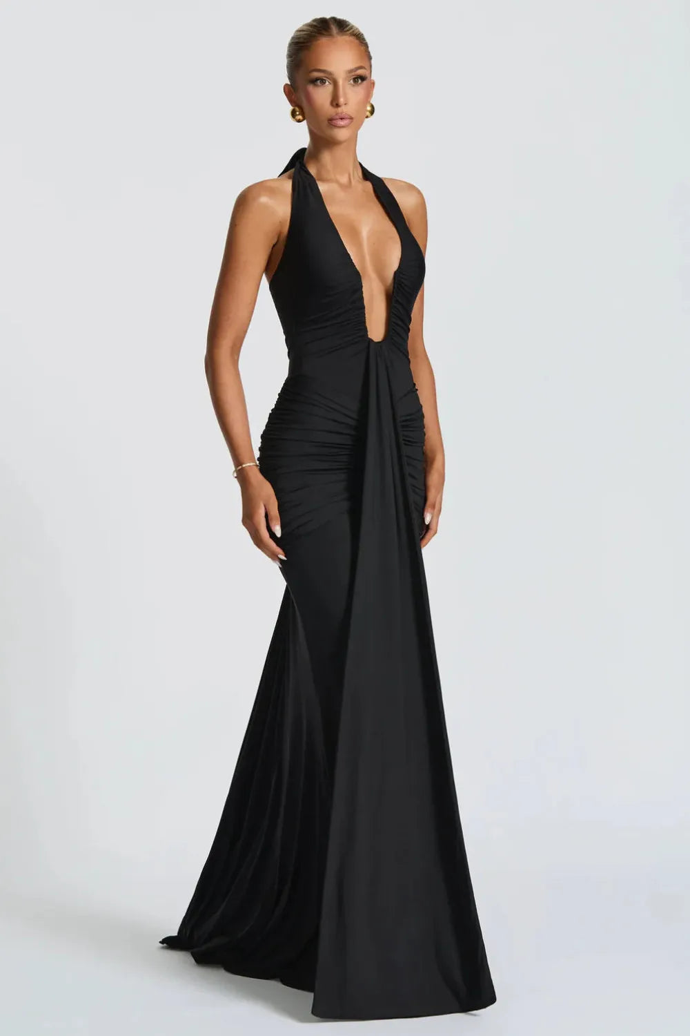 Black ruched maxi dress with halter plunge neckline and front draped panel.