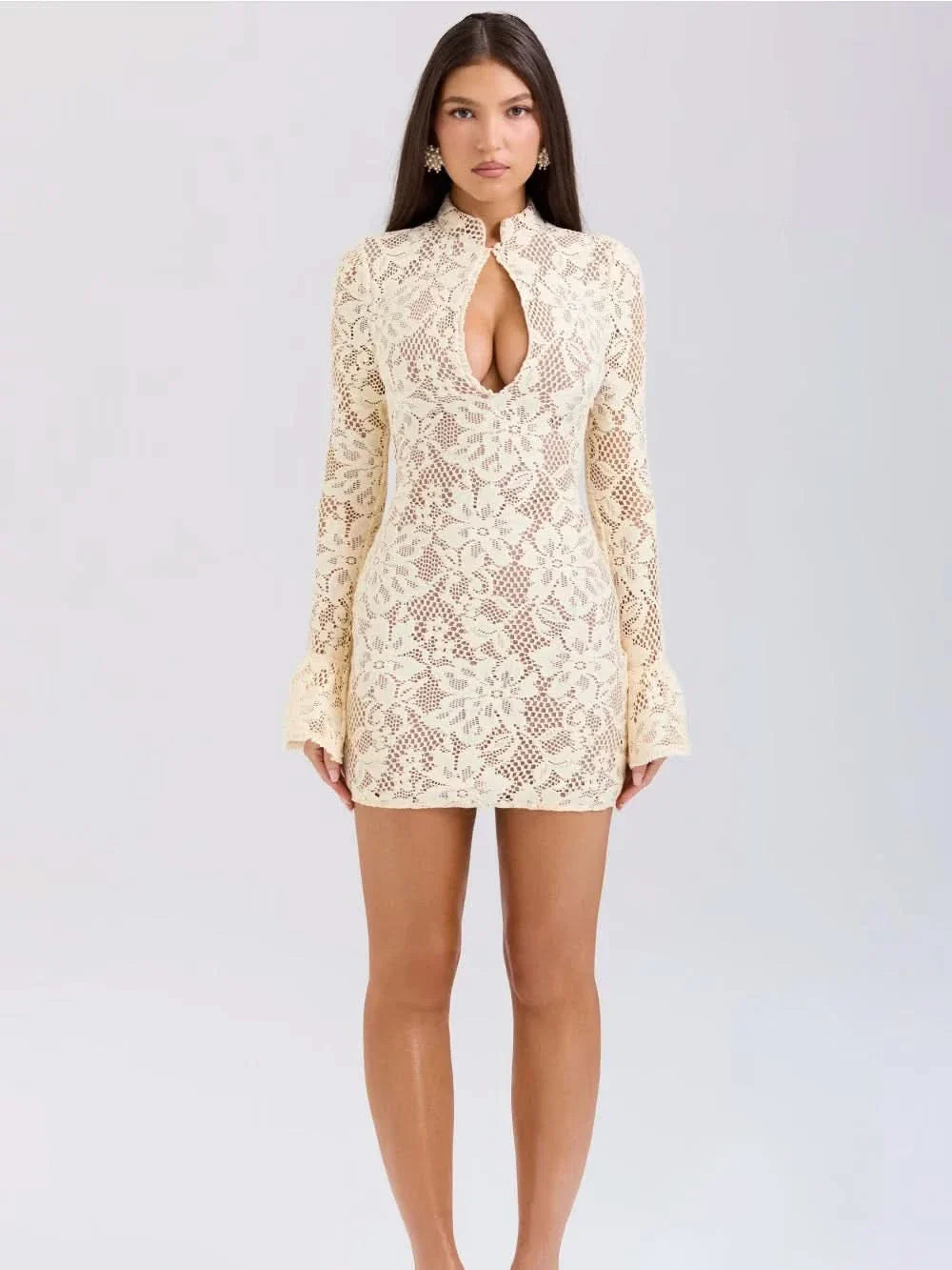 Full front view of a cream lace mini dress with long sleeves and a high neck keyhole, worn by a woman.